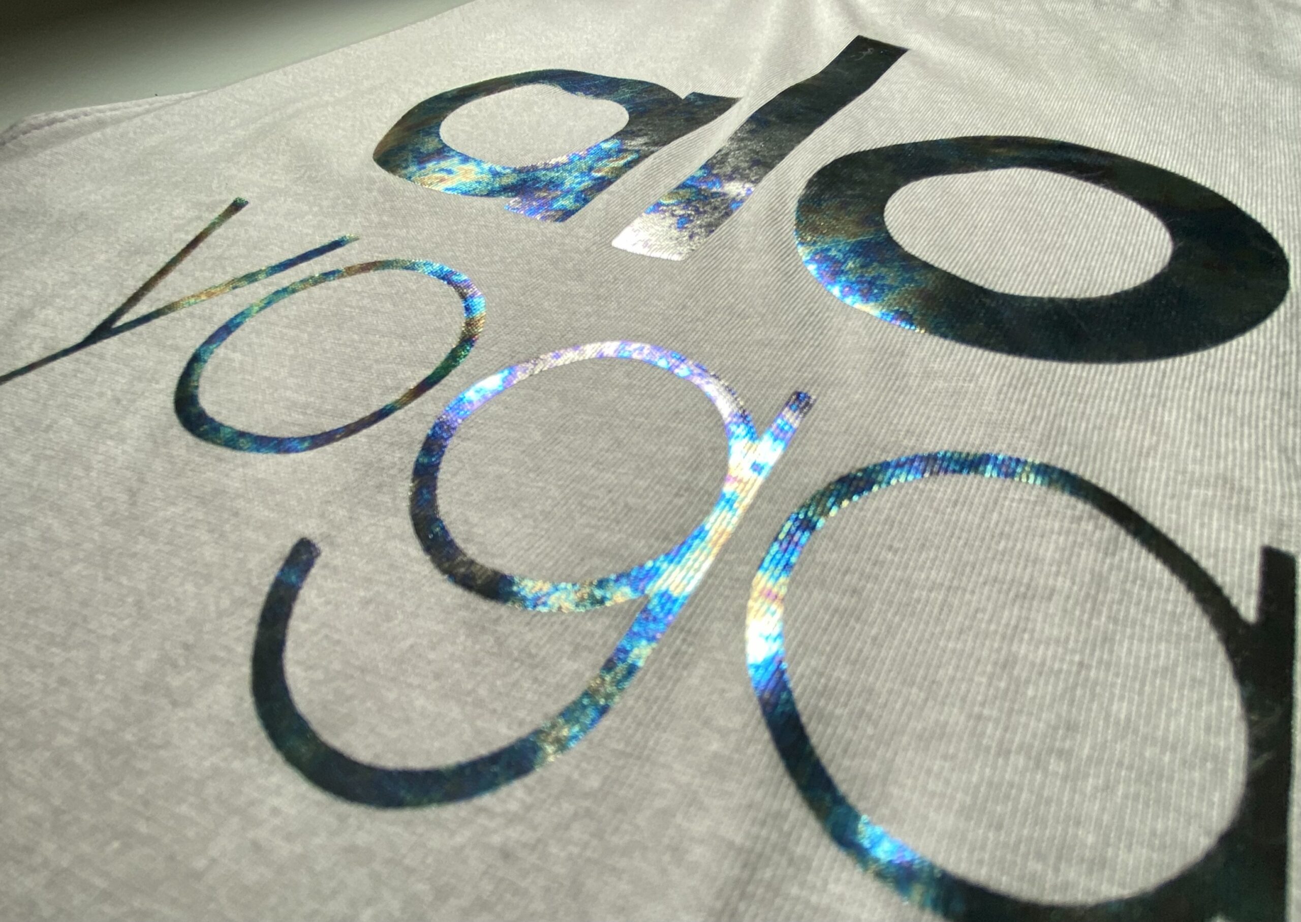 holographic foil lettering on a heather grey t-shirt