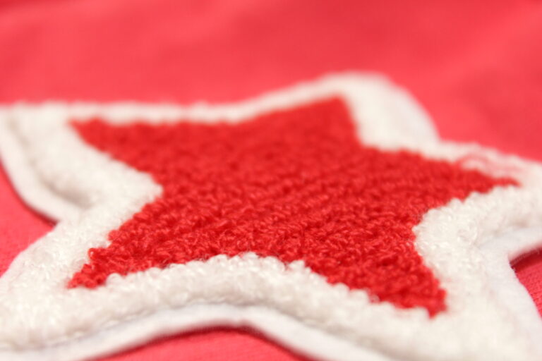 Red chenille star patch with a white chenille border