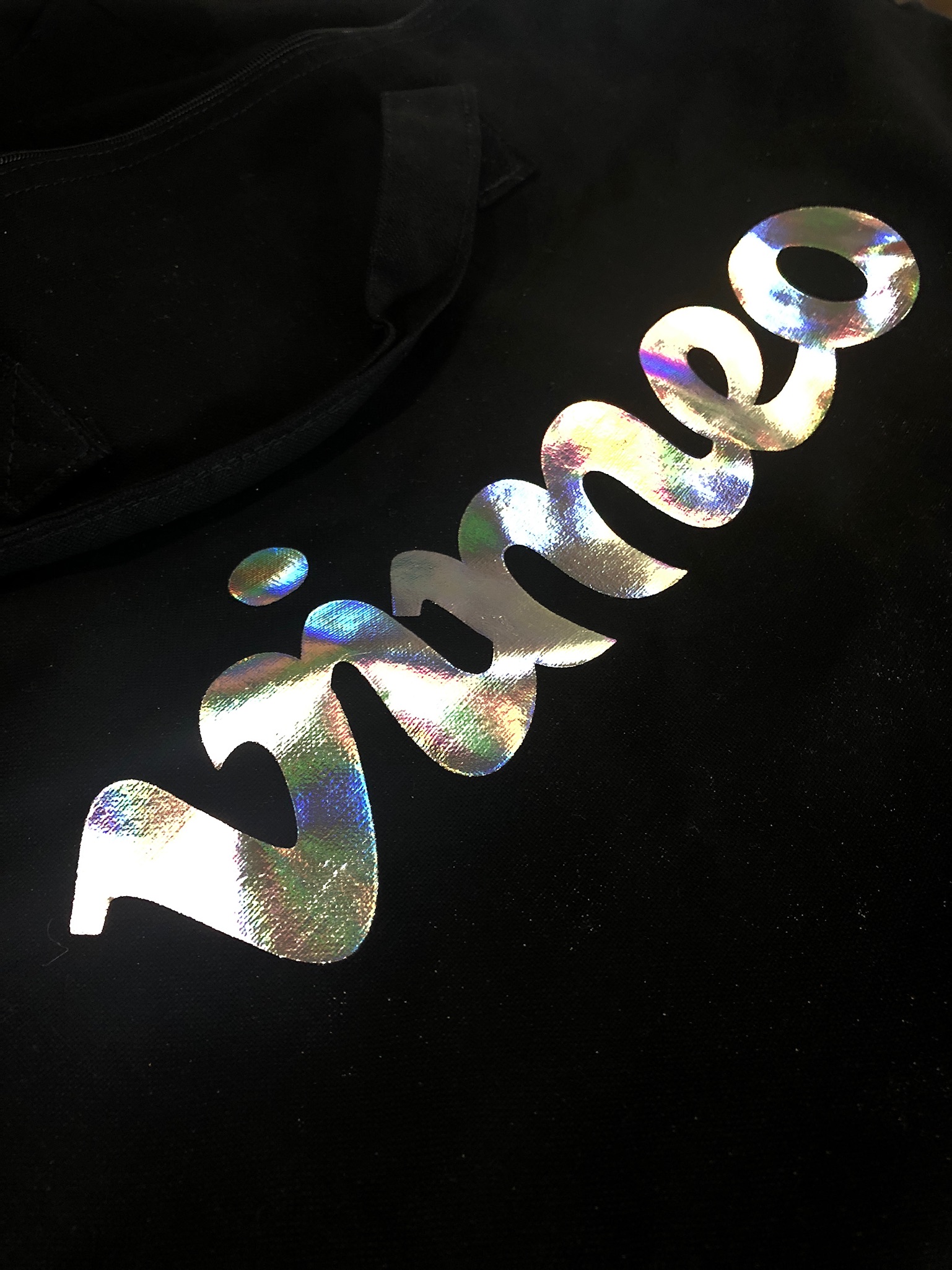 holographic foil script on a black garment