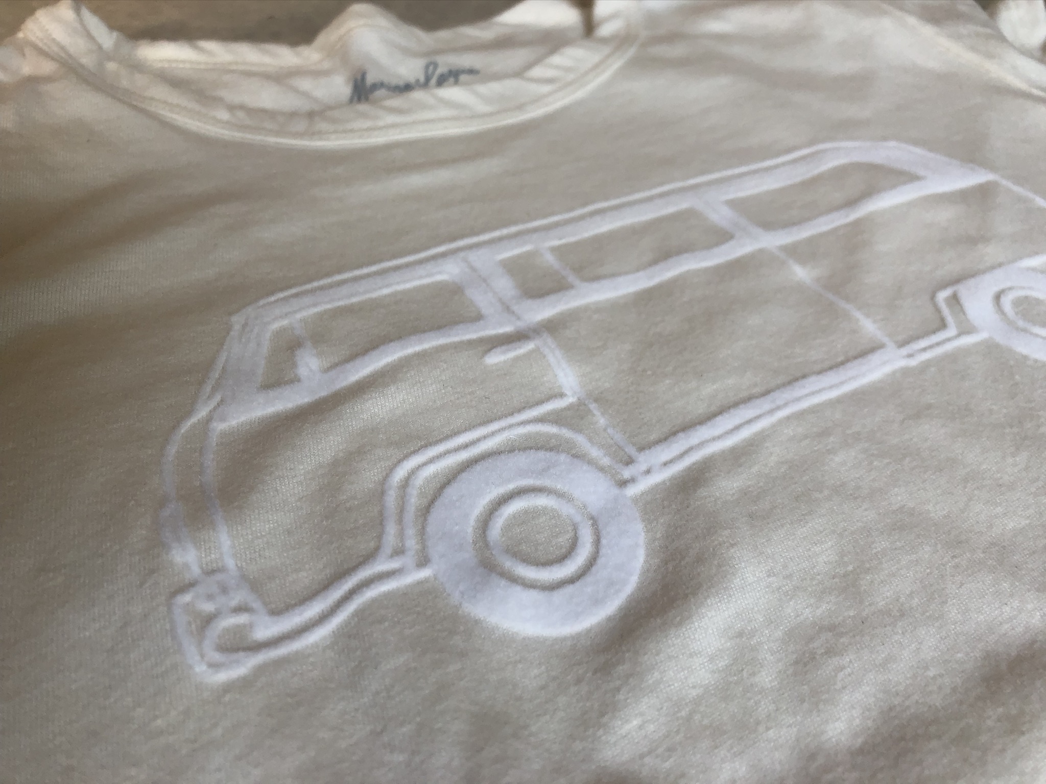 white flocked van outline on a cream t-shirt