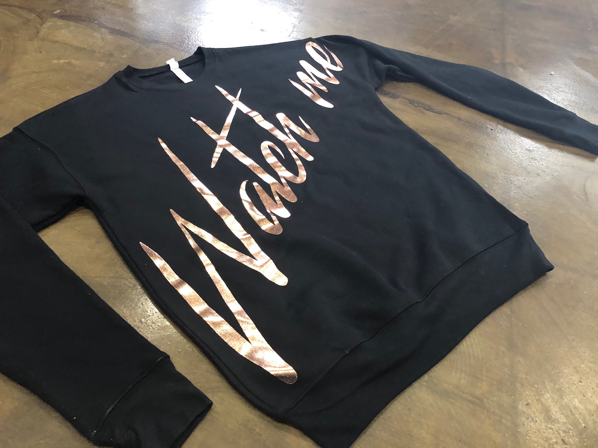 rose gold foil script on a black crewneck