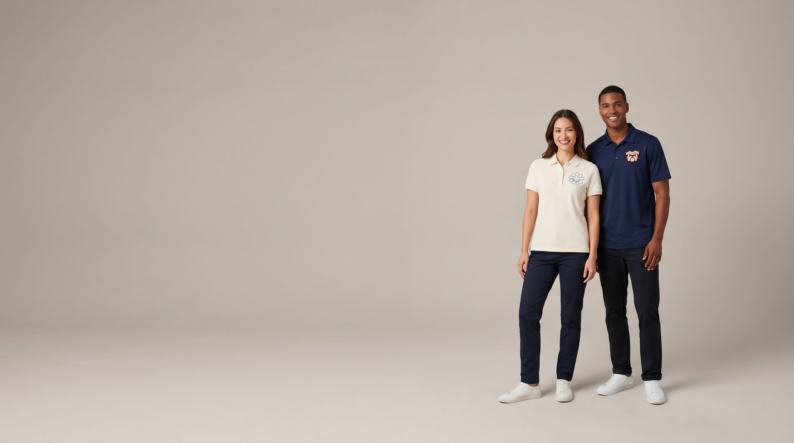 Two models wearing decorated everyday polos in a clean studio lookbook shot