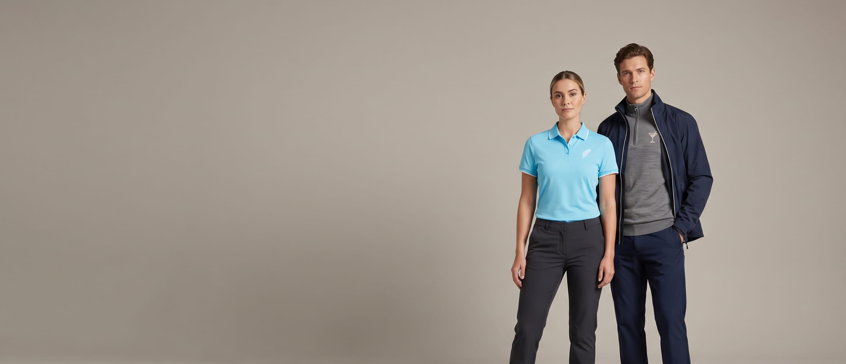 Two models with decorated Galvin Green premium golf apparel in a clean studio