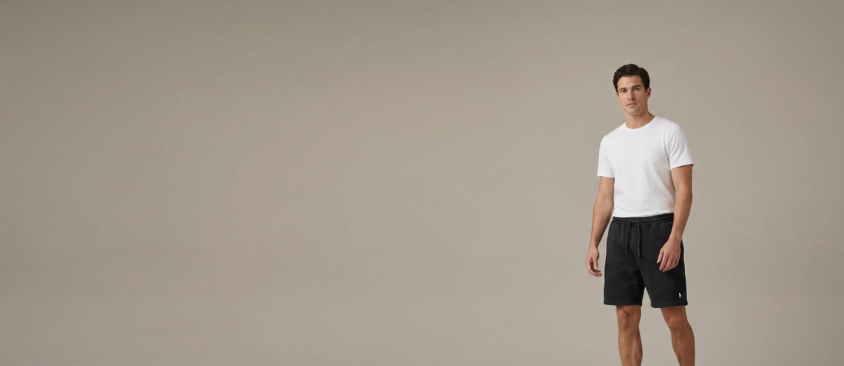 Man wearing custom decorated jogger shorts with embroidered logo