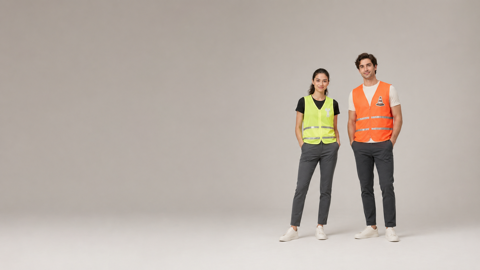 Two models with decorated Kishigo hi-vis safety vests in a clean studio