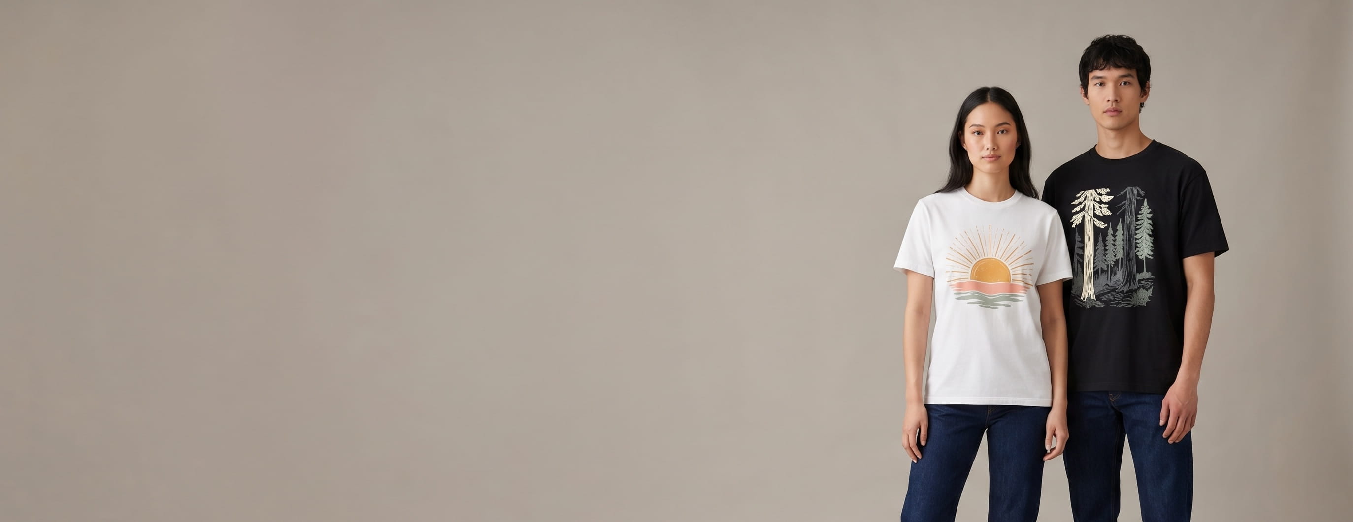 Two casual lifestyle models — woman in a white cotton crewneck with a full-chest vintage sunrise-layers water-based screen print, man in a black heavyweight cotton crewneck with a full-chest vintage redwood-forest DTG print