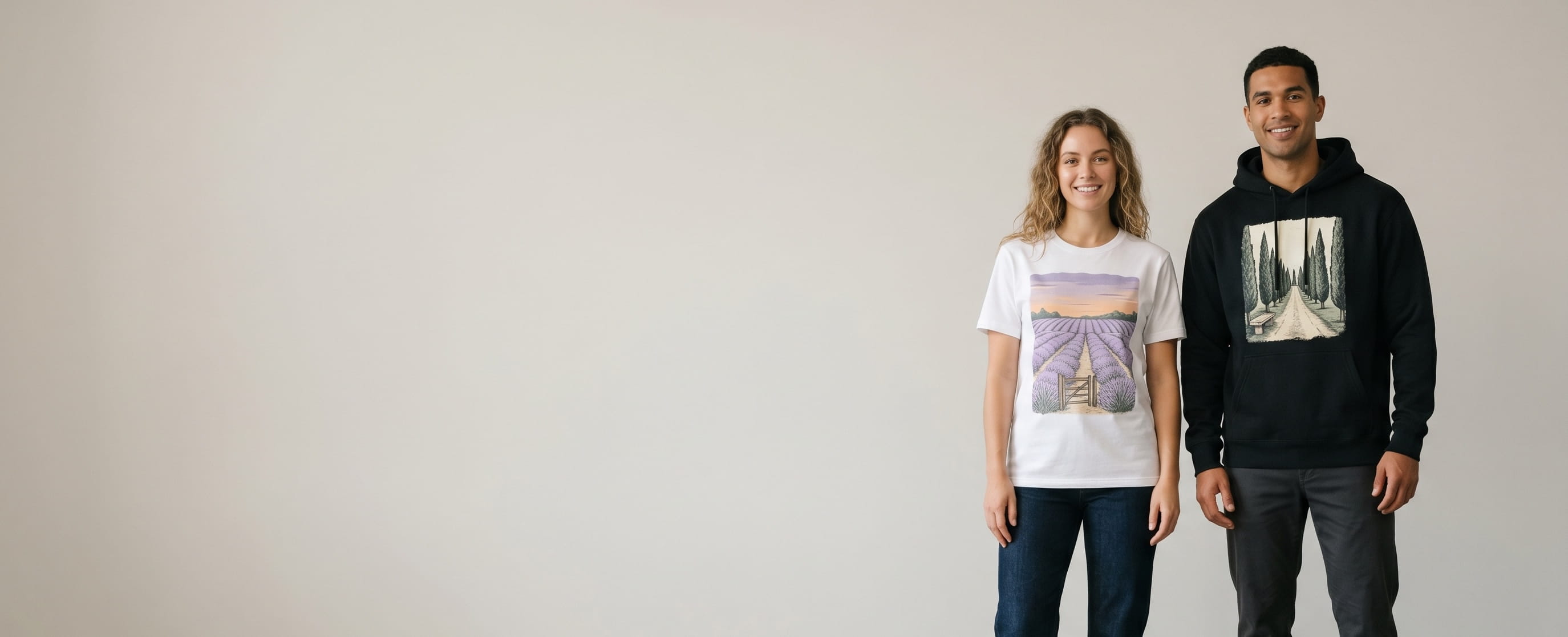 Two casual lifestyle models — woman in a white premium ringspun cotton crewneck with a full-chest vintage lavender-field at twilight water-based screen print, man (athletic) in a deep-black heavyweight fleece pullover hoodie with a full-chest vintage cypress-row lane DTG photographic print