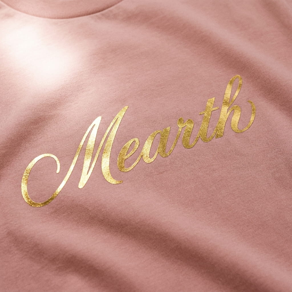 Gold foil script print on a t-shirt