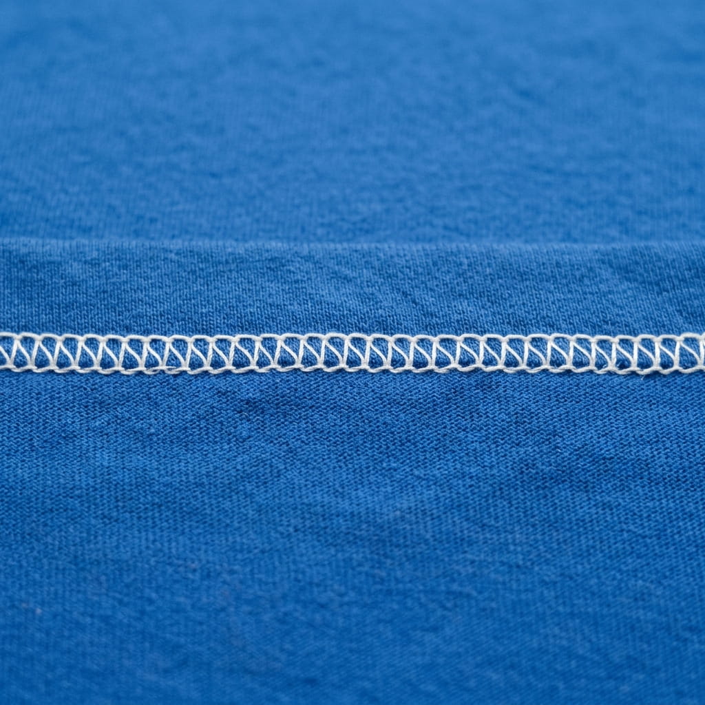 Detail of a stock blank with stark white poly stitching