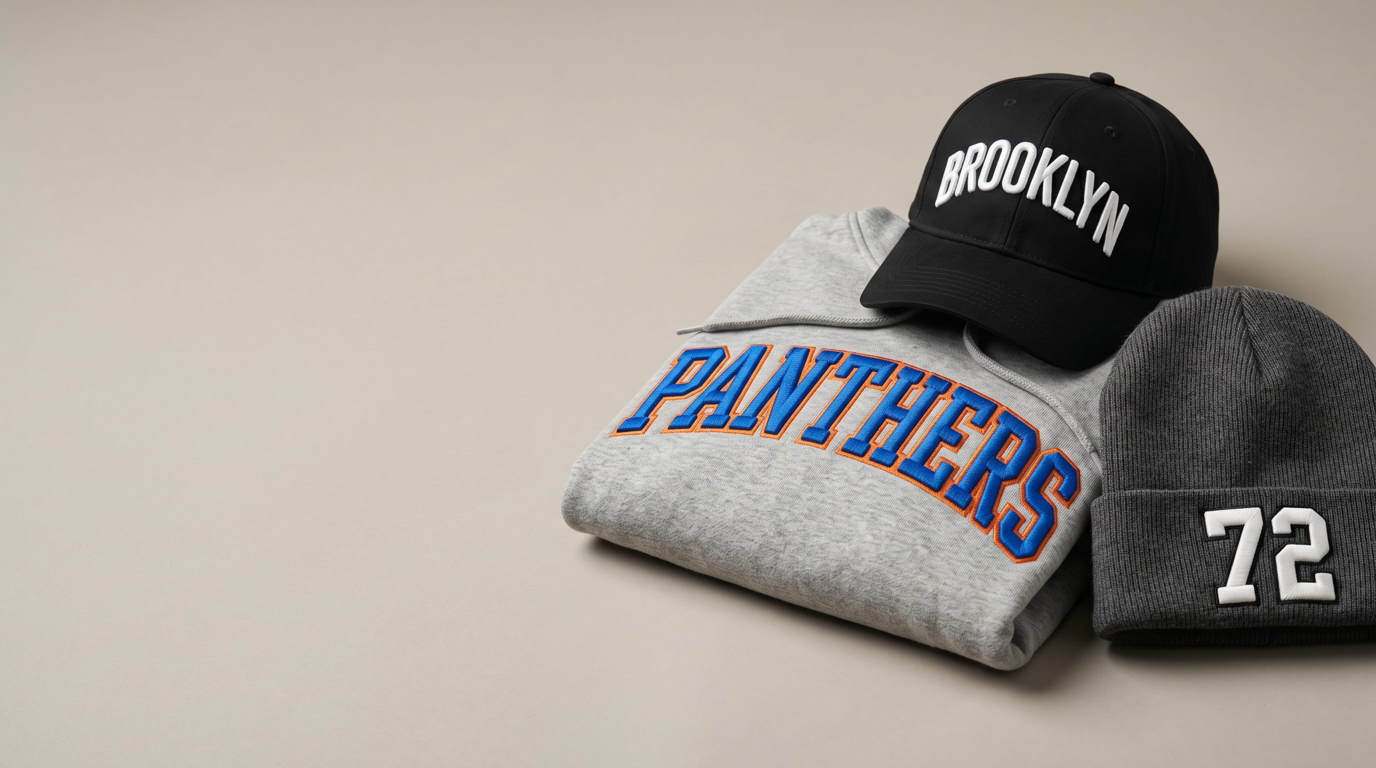 Bold raised 3D puff embroidery on a cap, hoodie and beanie