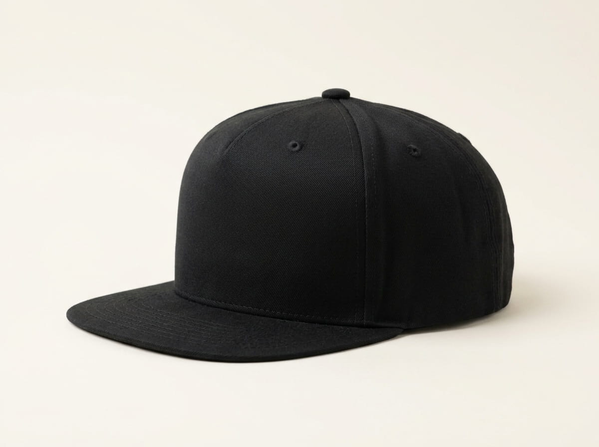 Custom snapback anatomy — structured high-profile crown, tall front panel, side panel, sewn eyelet vents, flat visor, adjustable snap closure