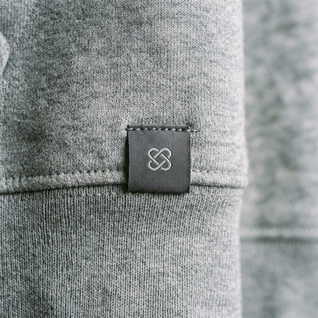 Woven logo label sewn into a garment hem