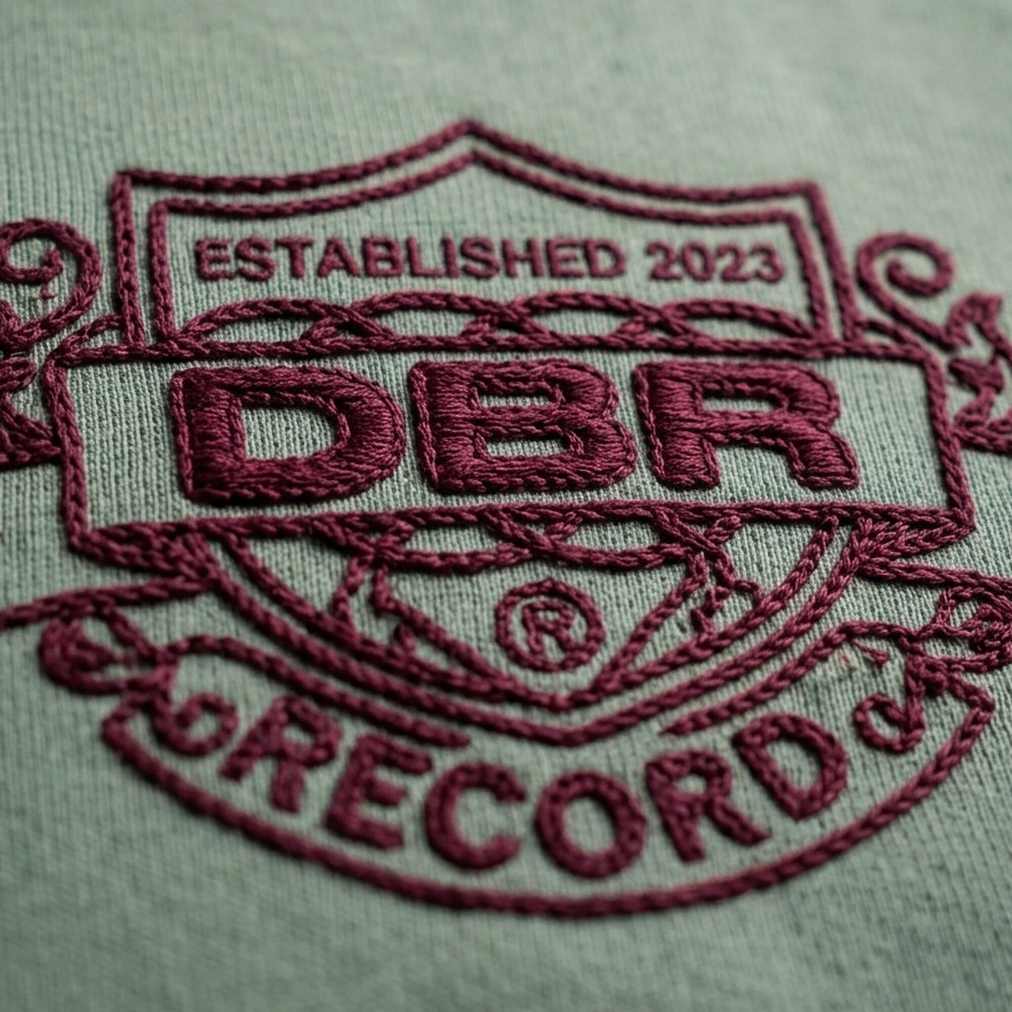 Bold computerized chain stitch lettering on a cap