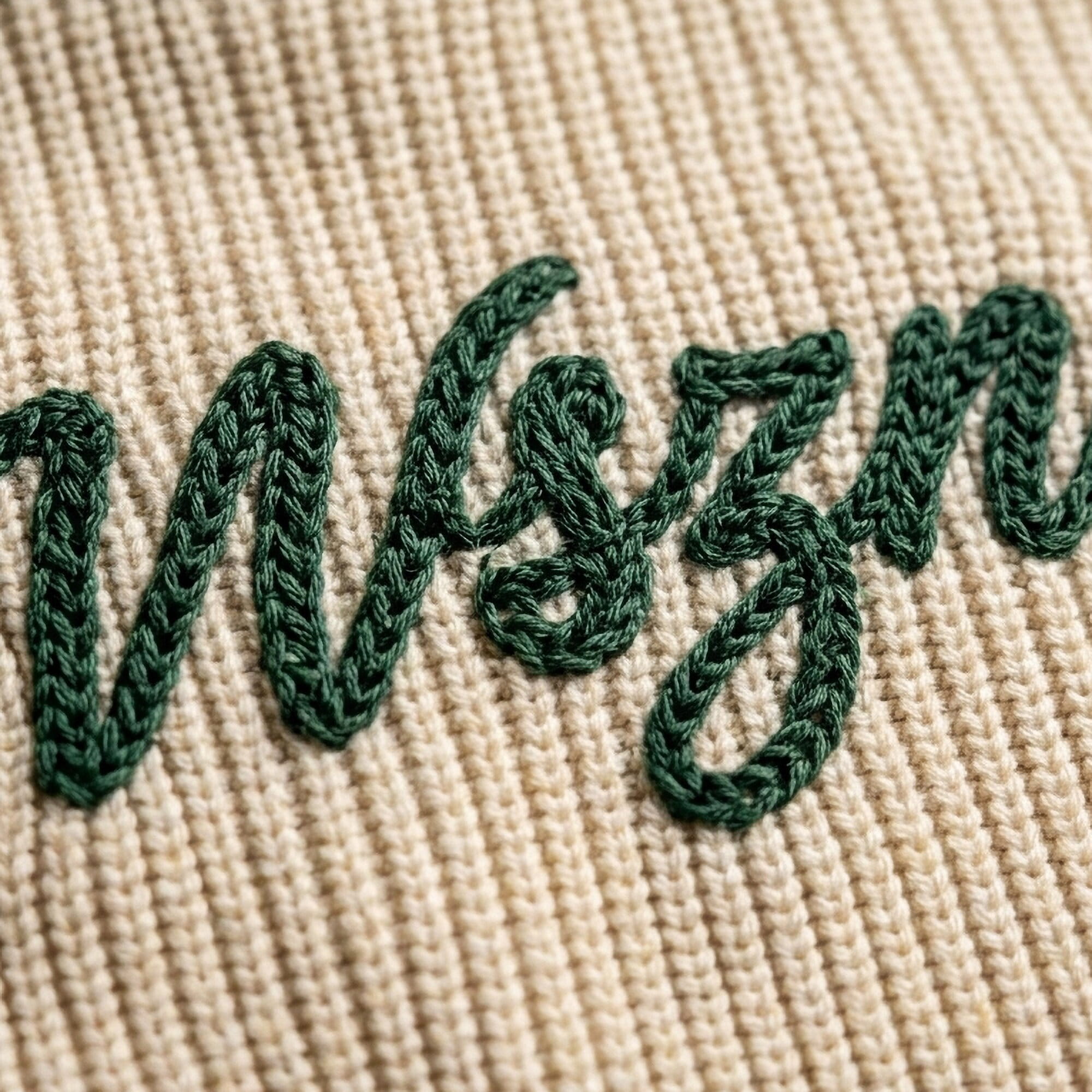 Looped vintage chain stitch script on denim