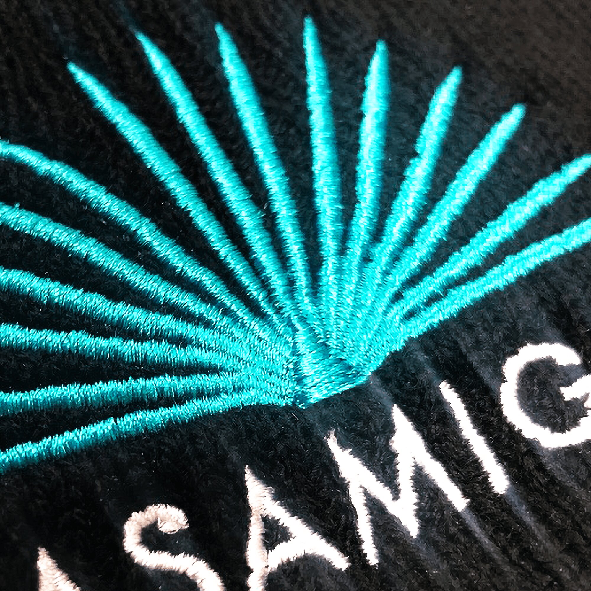Metallic-thread number embroidery on a cap