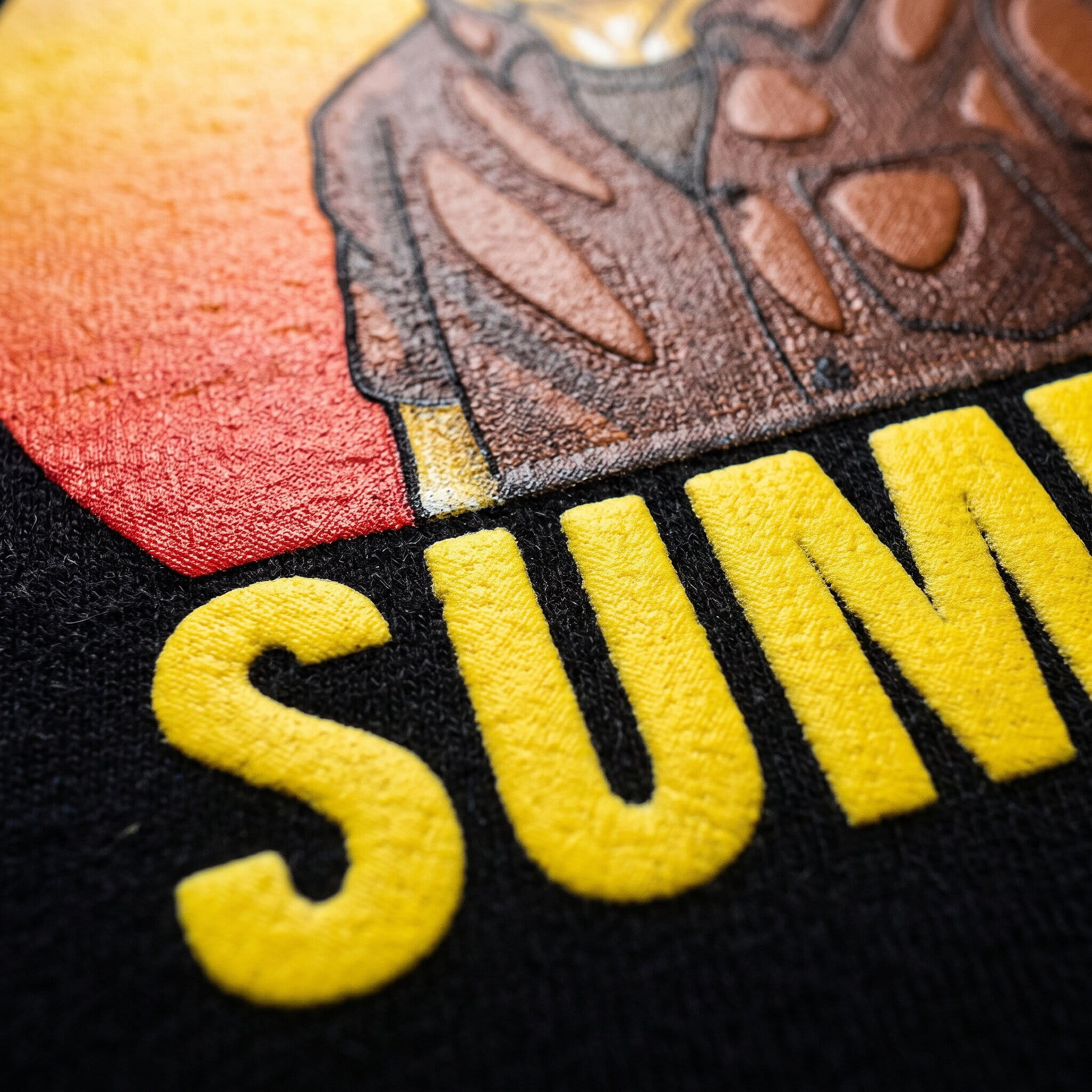 Close-up of a bold opaque plastisol print on a black t-shirt