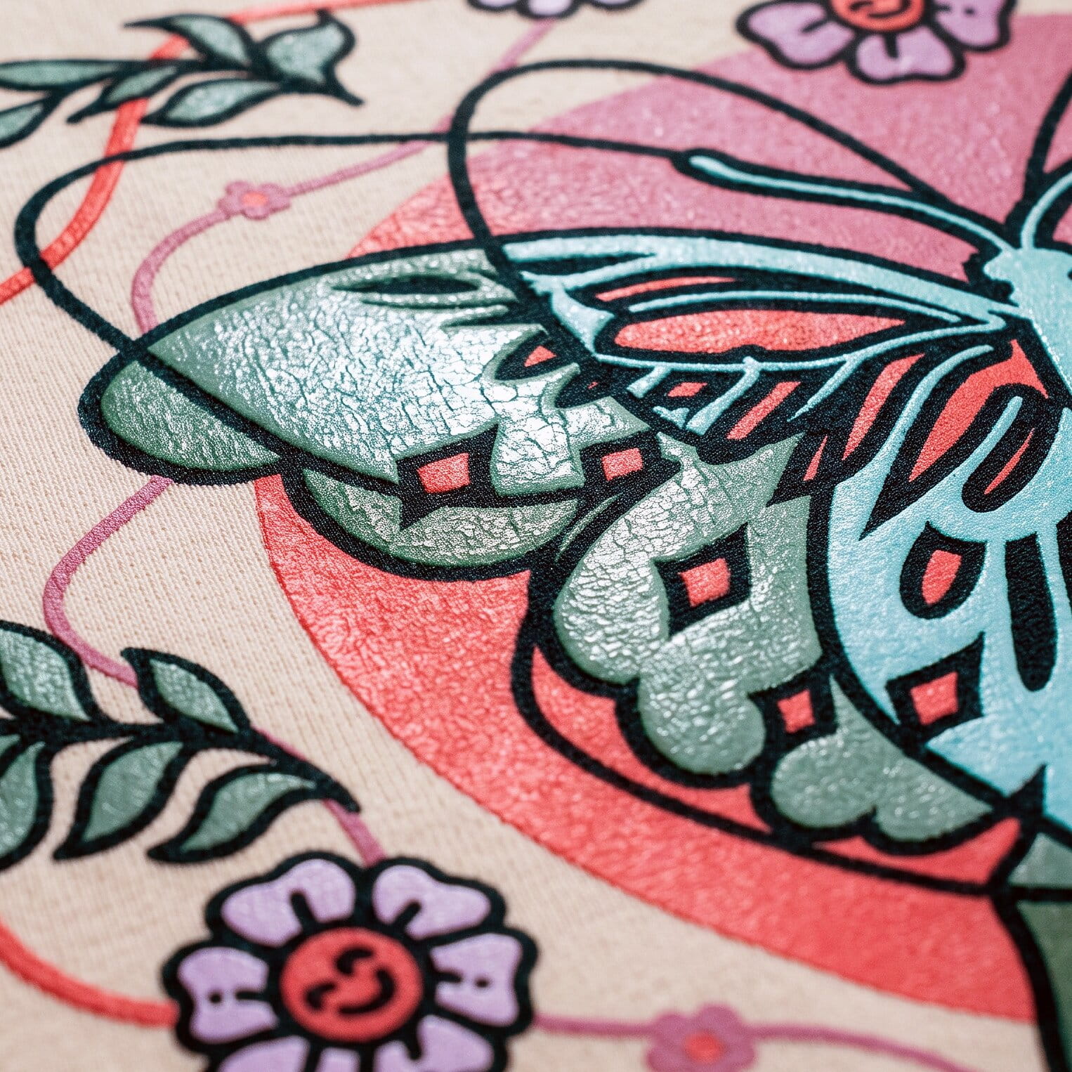close-up of a multi-color plastisol butterfly and flower print on a cream shirt