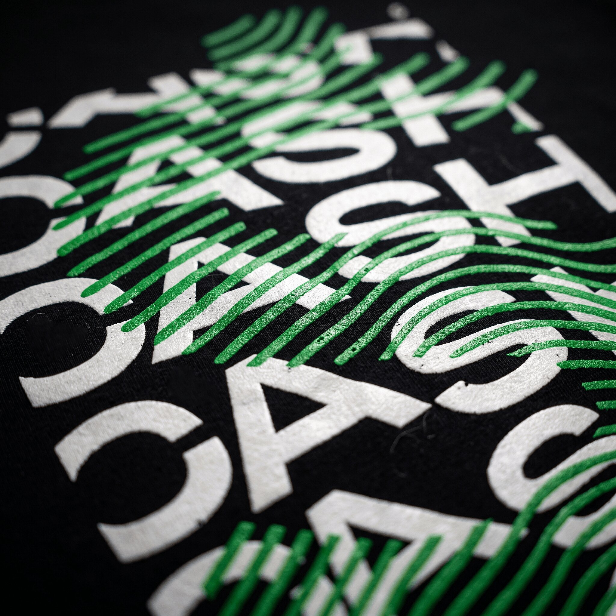 Close-up of a bold opaque plastisol screen print on a black t-shirt